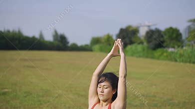 Slow motion Asian chinese female yoga yogi stretching in morning sun singapore
