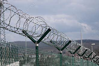 Barbed wire fence outside felony prison freedom stop trespassing security