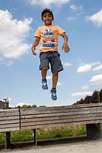 A child jumping, levitating in the air. Casual portrait.