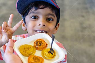 A happy child is excited to try new food. casual portrait