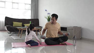 father and kid doing exercise together.