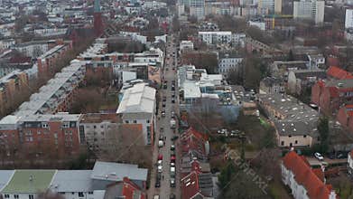 Following a car driving through urban city streets with reveal of Hamburg city center cityscape