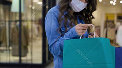 Video of woman in protective face mask during shopping.
