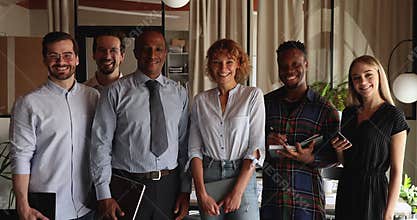 Portrait of happy friendly mixed race team posing in office.