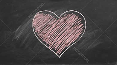 Heart drawn in red chalk on a blackboard