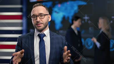 Stylish male news presenter talking financial trade information smiling. Television anchor