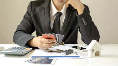 Businessman holding a lot of credit cards and stressful gesture from debts finance concept