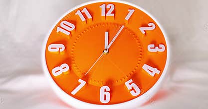 Time lapse on a modern orange wall clock