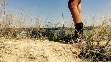 Female on the background of summer nature traditional American cowboy boots