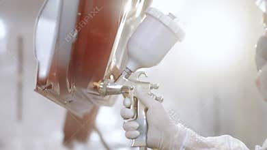 Close up of Modern paint booth for car painting, painter paints car details, bodywork. Paint the car in specialised