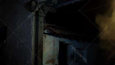 Late night shot of a creepy house with some smoke coming from the side