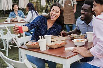 Multiracial people having fun doing selfie with mobile phone at food truck restaurant outdoor - Focus on african american man face