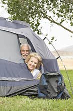 Senior Couple With Heads At Tent Flap