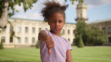 African American ethnic little girl female child kid daughter dissatisfied serious sad upset young schoolgirl school