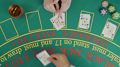Gaming and casino payment concept. Top view of blackjack casino table, female player waiting while croupier placing the