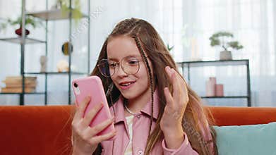 Happy child girl use smartphone typing playing browsing celebrate surprise win online casino game