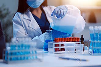 Group of dedicated scientist conduct chemical experiment in medical laboratory, carefully drop precise amount of liquid from