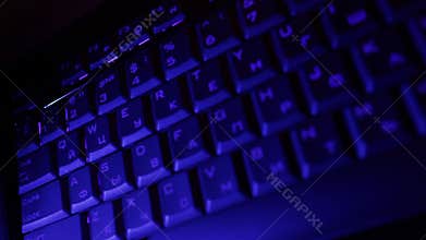 Man hands typing on the blue keyboard.