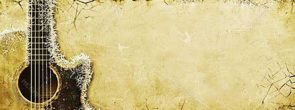 Guitar strings covered in frost on yellow grunge background