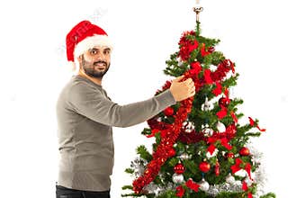 Man with santa hat decorate tree