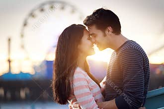 Romantic couple in front of santa monica at sunset