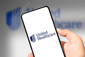 United Healthcare Mobile application concept with smartphone in hand, illustrative editorial. Top healthcare company