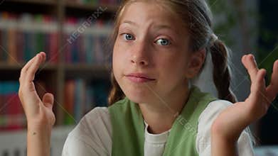 Close up sad upset confused Caucasian little girl puzzled child school kid student pupil schoolgirl looking camera