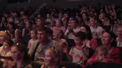 Audience applauded in theater or in cinema. Pan 2