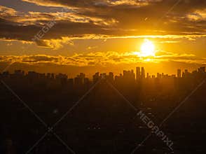 Stunning cityscape of Manila, Philippines with vibrant sunset and dramatic silhouettes created by warm sunlight on