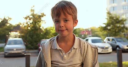 Young boy pretending to be superhero running in street