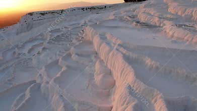 Aerial view of the travertines in Pamukkale in a beautiful sunset, Turkey. White limestone mineral formations. Turkish