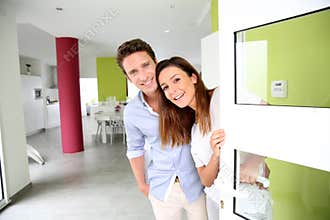 Couple welcoming people at home