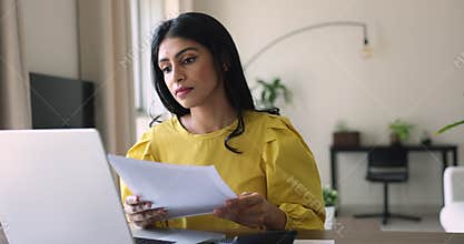 Serious Indian business woman do accounting job from home office
