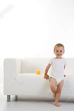 Child in front of couch/sofa
