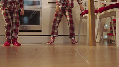 Cute boys dancing on the kitchen on Christmas Eve