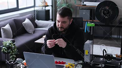Man Designer Constructing And Testing Electronic Prototype