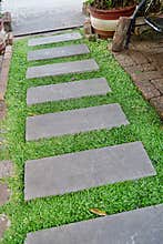 Footpath on green grass decoration garden , vintage brick wall old red brick wall texture background.