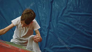 A strong boy trains climbing to become fitter and better. Top-down view