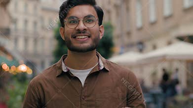 Excited Indian Arabian ethnic male man 20s guy bearded businessman happy student celebrating achievement victory