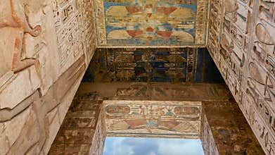 Hieroglypic carvings and columns in ancient Egyptian Temple of Medinat Habu at Luxor