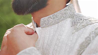 Inside the Indian wedding, the bridegroom brides together and worships the lord. Happy Indian groom handsome portrait