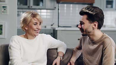 Concept of family reunion. An adult young son support his mature age single mother. Spend time with family. Mid shot