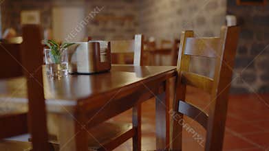 Selective focus on wooden table and empty chair in cozy cafe