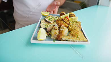 Second Service With Breaded Swordfish And Octopus Rolls In A Restaurant
