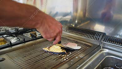 Chef Turns Swordfish On The Grill At A Restaurant