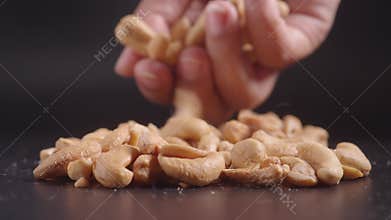 Closeup of hand pick cashew nuts