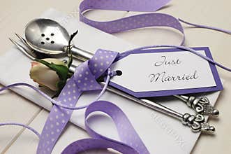 Purple and white shabby chic wedding table setting. Close up.