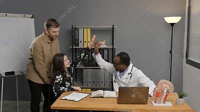 Black doctor consulting girl with father for covid, allergies or hospital