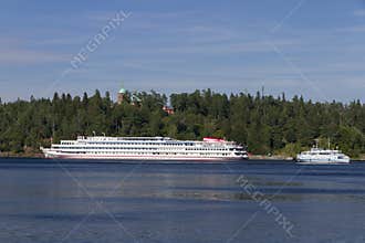 A cruise ship against the background of the island and church domes