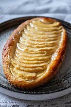French fresh baked sweet puff pastry with fresh apple fruits in sirup in confectionery shop